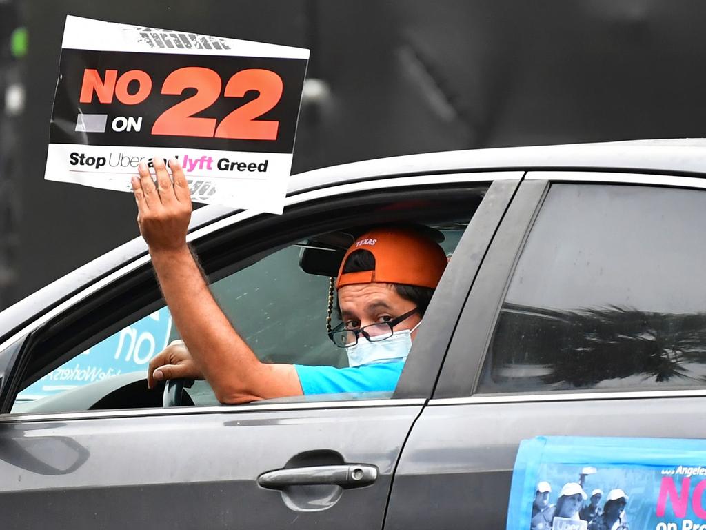 A protesting driver urges Californians to vote no on proposition 22. The state voted yes. Picture: Frederic J. Brown/AFP