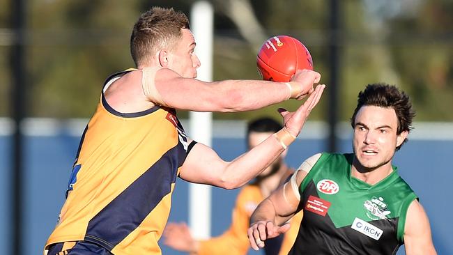 Tom Gleeson fires off a handball during his days at Strathmore. Picture: Josie Hayden