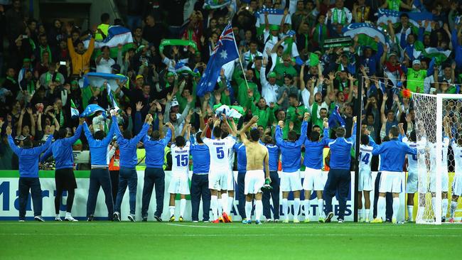 Uzbekistan players and officials celebrate after they defeated Saudi Arabia.