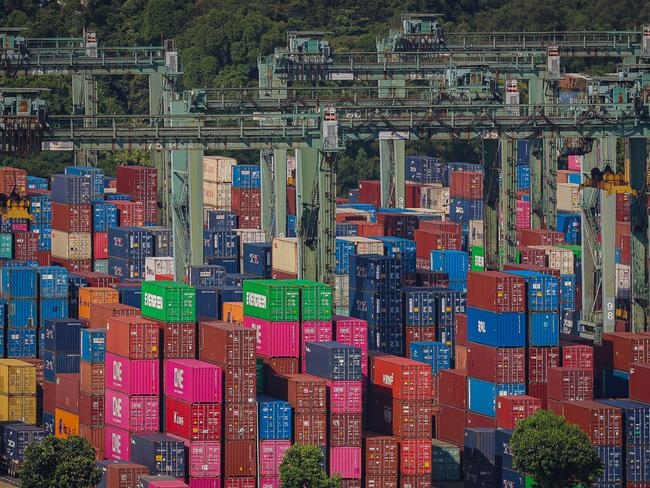 SINGAPORE, SINGAPORE - APRIL 12: Gantry cranes stand as containers stack below at Brani Terminal, operated by PSA (Port of Singapore Authority) International Pte, on April 12, 2025 in Singapore. Singapore, one of the world's most trade-dependent economies, faces significant challenges amid escalating global trade tensions and protectionist policies. The recent imposition of universal tariffs by the United States, including a 10% baseline tariff on Singapore's exports, has disrupted trade flows and weakened external demand. Singapore is particularly vulnerable to these shifts as a small, open economy with outward-oriented sectors such as manufacturing, wholesale trade, and transport. Prime Minister Lawrence Wong has warned that the tariffs represent a 
