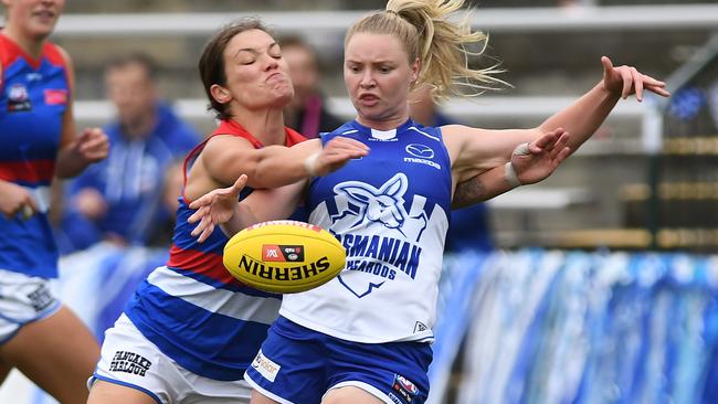 HOBART, AUSTRALIA - MARCH 13: Daria Bannister of the Kangaroos is tackled during the round seven AFLW match between the North Melbourne Kangaroos and the Western Bulldogs at North Hobart Oval on March 13, 2021 in Hobart, Australia. (Photo by Steve Bell/Getty Images)