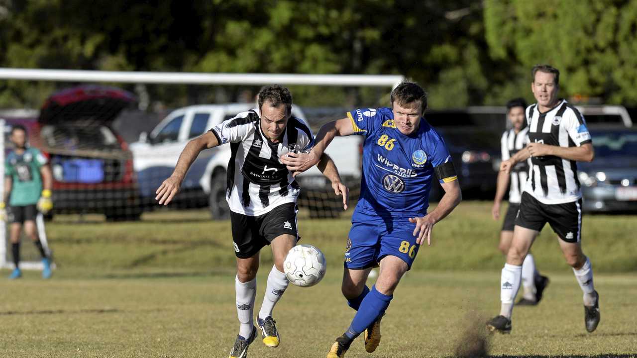 CLOSE BATTLE: Willowburn's Peter Millican (left) competes for the ball with USQ FC's Brendan Willmot. Willowburn was the only team to beat minor premiers USQ this season. Picture: Kevin Farmer