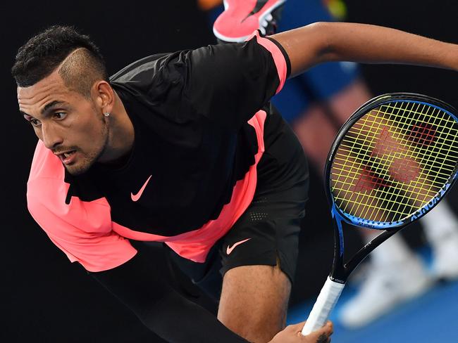 Australia's Nick Kyrgios serves to Serbia's Viktor Troicki during their men's singles second round match on day three of the Australian Open tennis tournament in Melbourne on January 17, 2018. / AFP PHOTO / Greg Wood / -- IMAGE RESTRICTED TO EDITORIAL USE - STRICTLY NO COMMERCIAL USE --