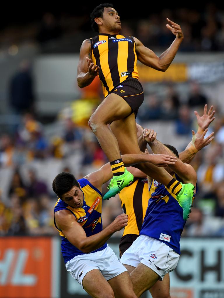 We can hear Bruce McAvaney from here salivating over Cyril Rioli using two West Coast players as stepladders Picture: Mal Fairclough/AAP.