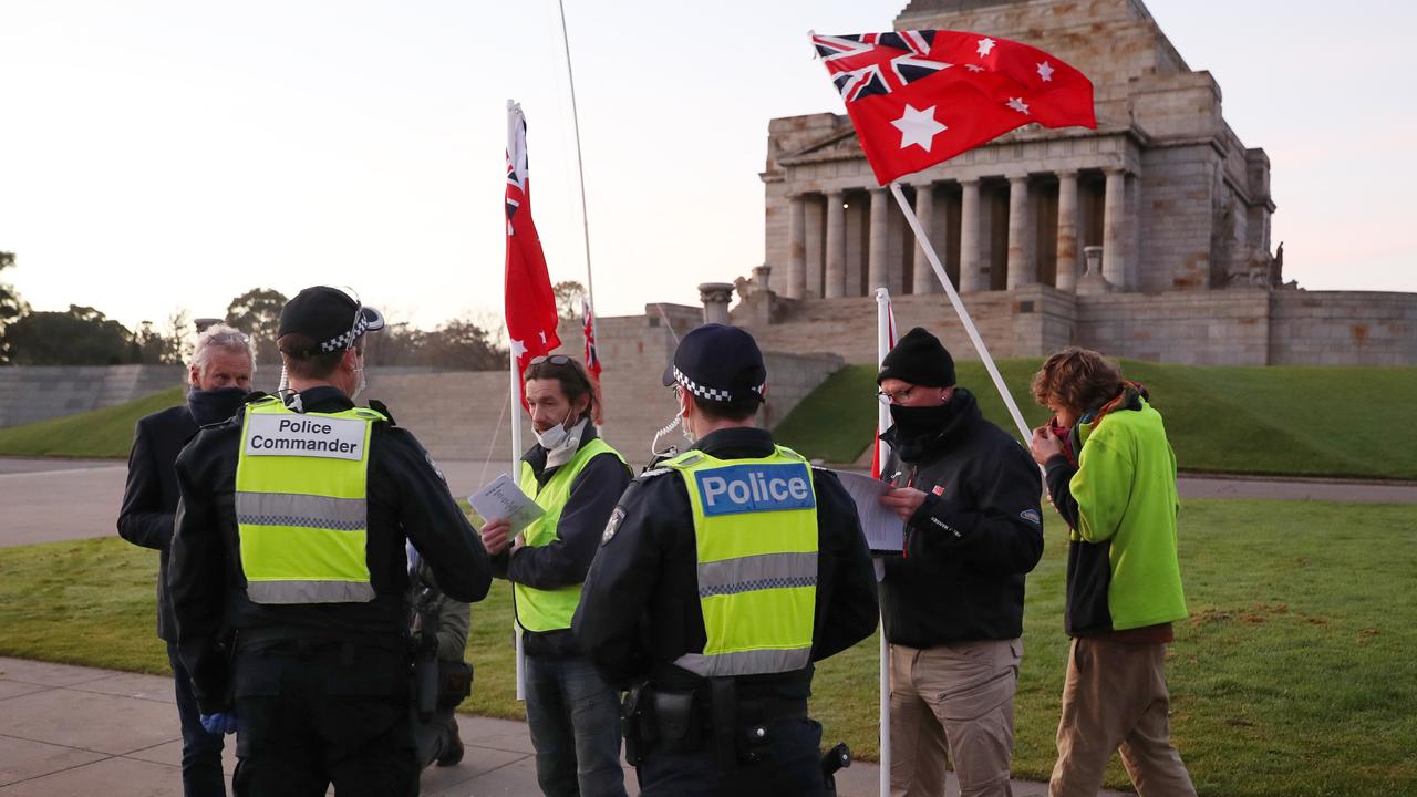 Police talk to the anti-mask protesters at the Shrine of Remembrance. Picture: NCA NewsWire /David Crosling