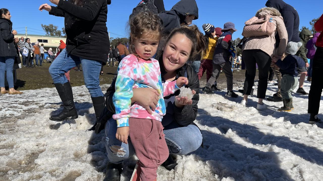 Rosewood mother and daughter Maia Taitapanui (3) and Ashlee Baker make snowballs in the the snow at Snowflakes in Stanthorpe 2021 festival. Photo: Madison Mifsud-Ure / Stanthorpe Border Post