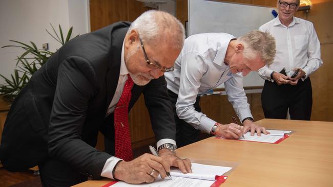 Citra Bangsa School of Kupang's chair Abraham Liyanto and Darwin's Haileybury Rendall School School principal Craig Glass have signed an agreement to run a new student exchange program until 2023. Picture: KERI MEGELUS