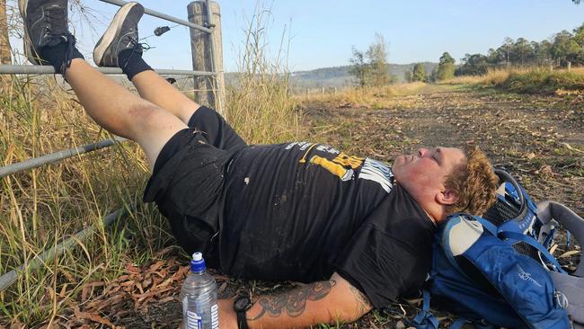 Charlie Hughes takes a rest during his 230km walk from Nanango to Coorparoo.