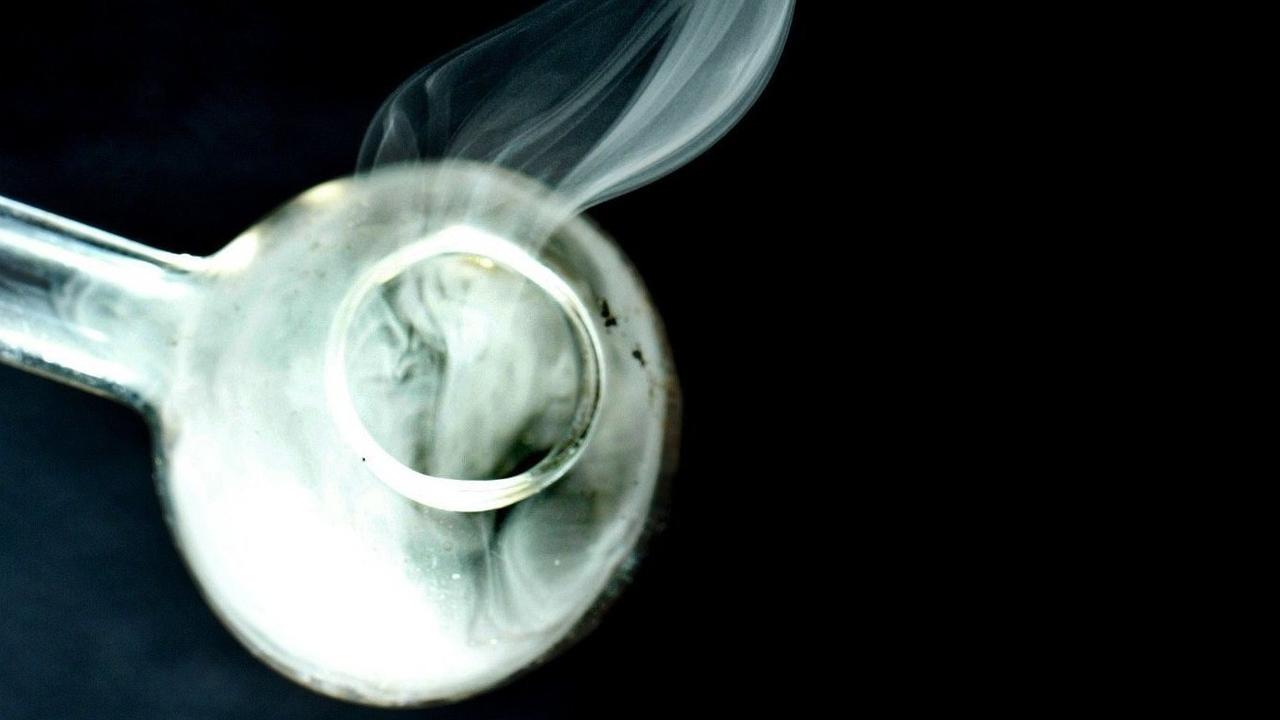 Methamphetamine pure crystals being heated in a glass pipe by a police drugs officer during a controlled demonstration. Photo: Martin Sykes