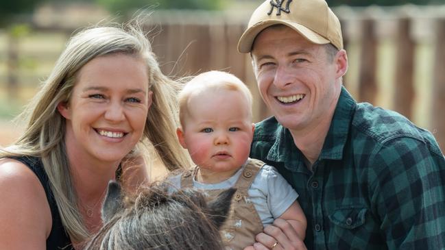 Jockey Harry Coffey with his wife, Tayla, their 10-month-old son, Thomas, and Shetland pony Bruno on their Swan Hill property. Picture: Jay Town/VRC