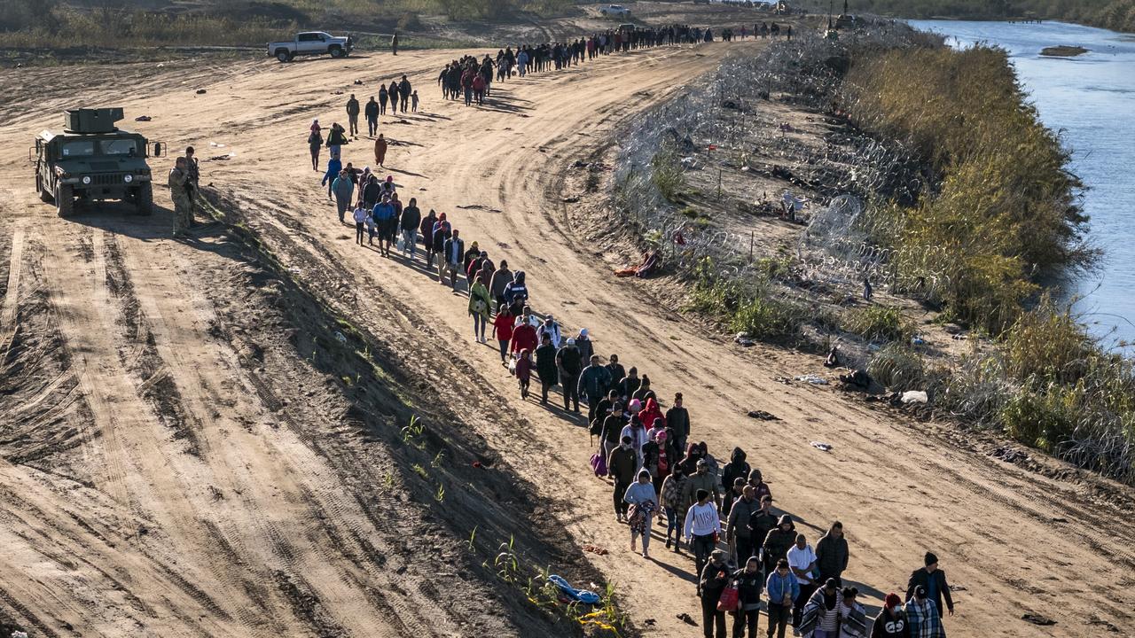 A group of more than 1000 immigrants walks towards a US Border Patrol field processing centre after they crossed the Rio Grande from Mexico. Picture: John Moore/Getty Images