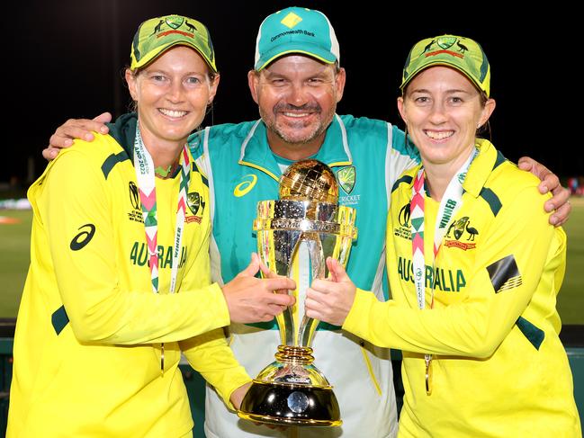 Meg Lanning, Matthew Mott and Rachael Haynes pose with the trophy after Australia won the 2022 ICC Women's Cricket World Cup in April. Picture: Phil Walter-ICC/ICC via Getty Images