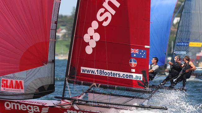 Multiple world champion Trevor Barnabas, right, and son Trent, left, racing their 18-footer skiff on Sydney Harbour.