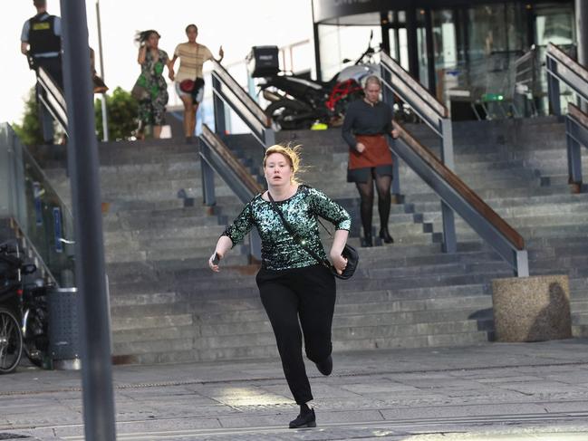 People are seen running as police evacuate of the Fields shopping center in Copenhagen, Denmark. Picture: AFP