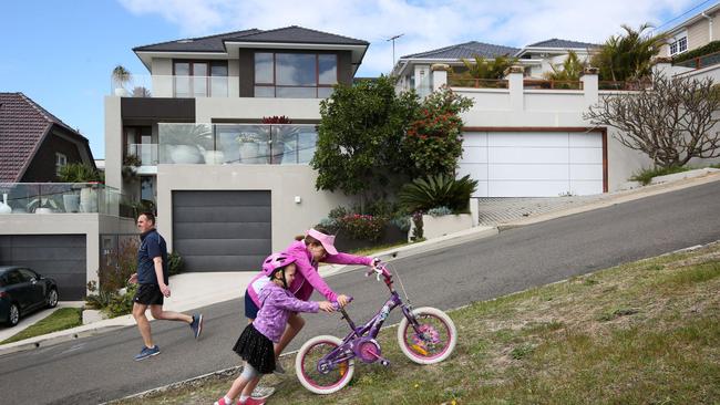 Madeleine Kordina (4) and Amelie Kordina (9) make hard work of Rainbow St, near to the finish line. Picture: AAP / Image Bob Barker