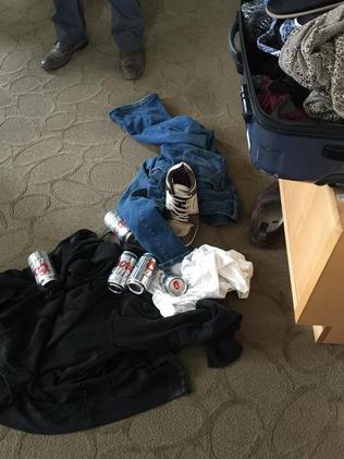 Nicole Ashley Squires opened her luggage to find men's clothing and cans of beer. Picture: Nicole Ashley Squires