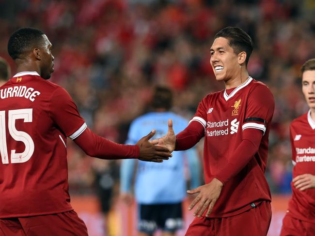 Liverpool's Daniel Sturridge (L) congratulates teammate Roberto Firmino (C) after his goal