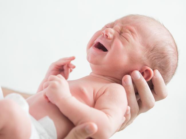 Portrait of a screaming newborn hold at hands, family, healthy birth concept photo, close up  - Picture istock