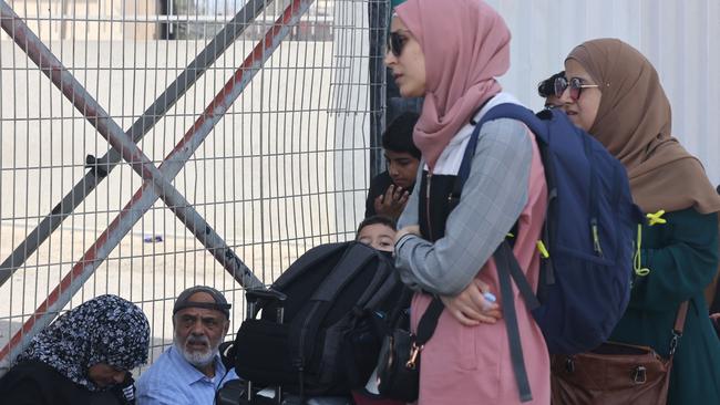 Palestinians with duel citizenship wait outside the Rafah border crossing with Egypt. Picture: AFP =