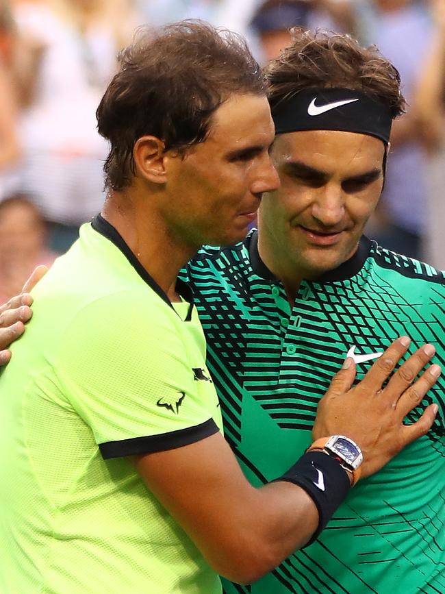 Roger Federer hugs it out with Rafael Nadal at the net. Photo by Clive Brunskill/Getty Images.