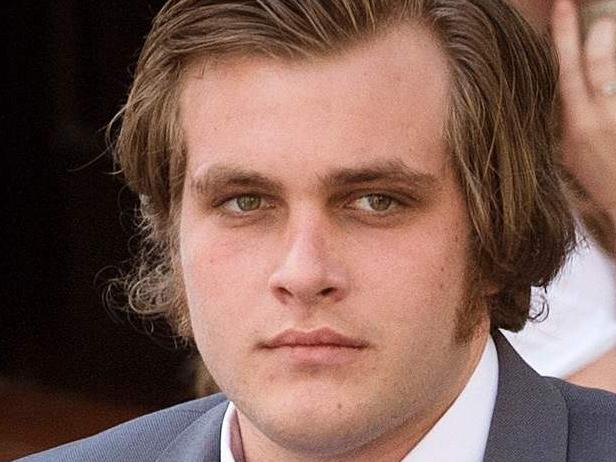(FILES) This file photo taken on March 27, 2017 shows Henri van Breda (C) arriving with his lawyer Lorinda van Niekerk (L) at the Western Cape High Court for the start of his trial for allegedly killing his two parents, brother, and wounding his sister, with an axe, in their luxury home, in Cape Town.  In a case that has gripped South Africa, the 22-year-old scion of a wealthy family goes on trial in Cape Town on April 24, 2017, accused of slaughtering his family in a frenzied axe attack. The case has also made headlines internationally, as police failed to arrest anyone for the grisly killings until Henri van Breda handed himself in. / AFP PHOTO / RODGER BOSCH