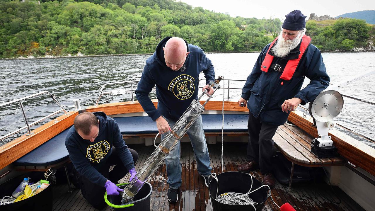 Professor Neil Gemmell (centre) takes samples on his boat as he conducts research into the DNA present in the waters of Loch Ness in 2018. Picture: AFP