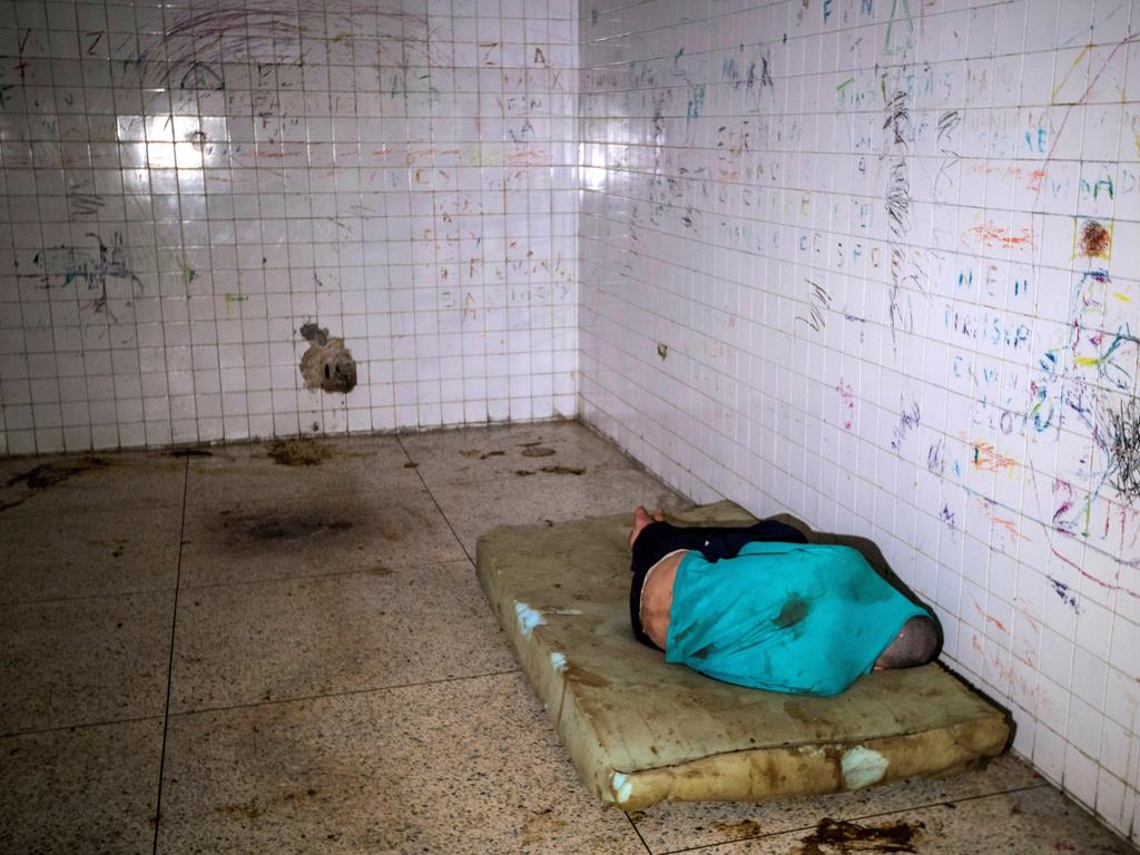 A mental health patient at the Caracas Psychiatric Hospital lies on a dirty mattress and excrement surrounds him. Picture: AAP/EPA