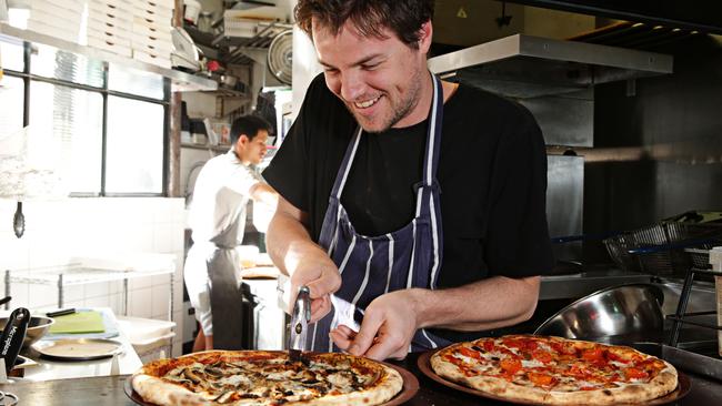 Tony Gardner at work in the iny kitchen. Photo: Adam Yip.