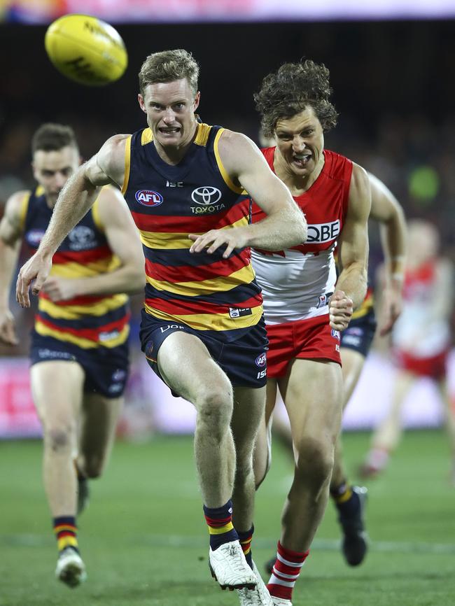 Former Crow turned Swan Kurt Tippett, back, chases current Crow Alex Keath. Picture: Sarah Reed