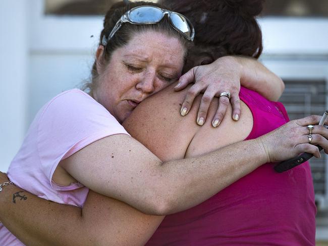 Carrie Matula embraces a woman after the shooting that has killed at least 26 people. Picture: AP