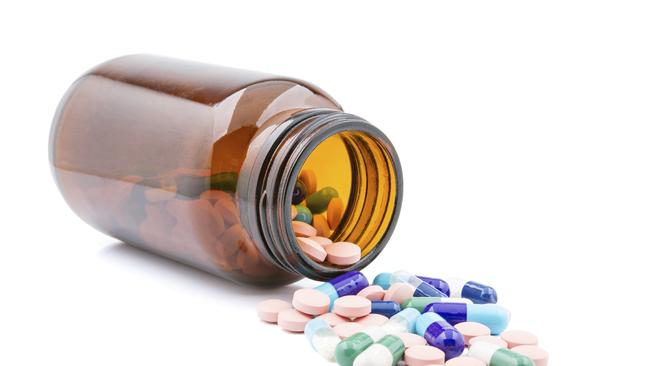 Group of pills in bottle on a white background.