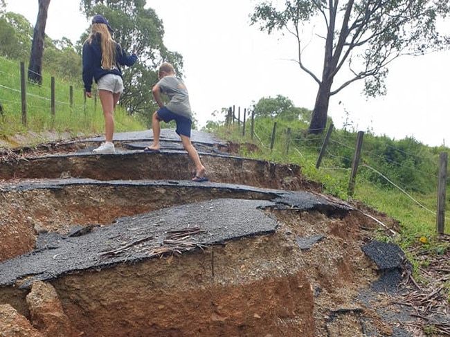 Dave Anderson’s kids climb the driveway at their Neranwood property after the land slip Picture: Supplied