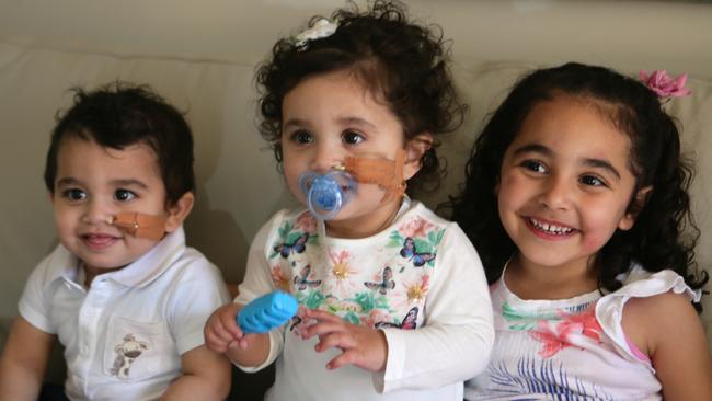 Twins Isaac and Charlize Gravina have a giggle with big sister Amelia, 4.