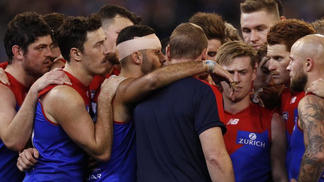 Demons players huddle around Goodwin. Pic: AAP