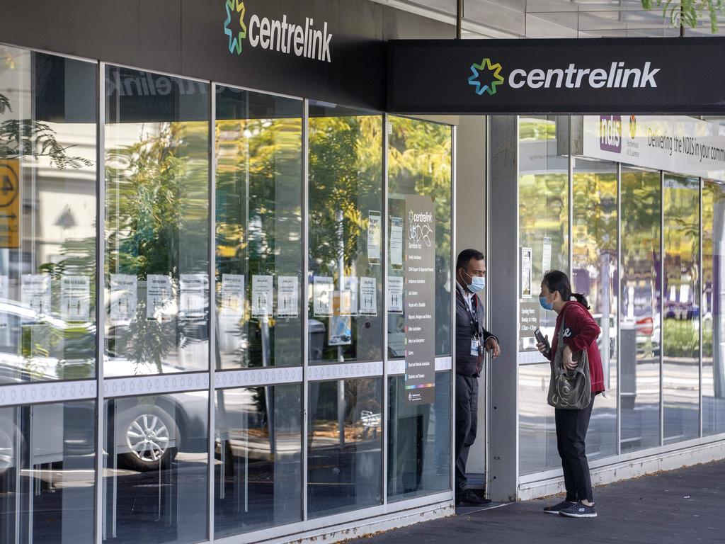 A woman talks to a staff member at Centrelink in South Melbourne. Picture: NCA NewsWire / David Geraghty