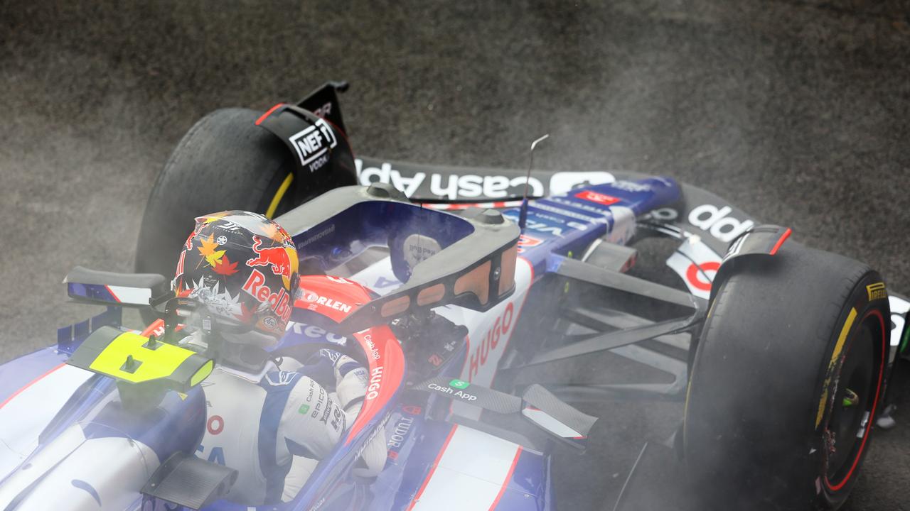 Yuki Tsunoda climbs out of his cockpit after crashing. (Photo by Mark Thompson/Getty Images)