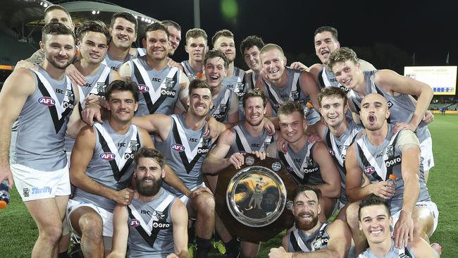 Port Adelaide celebrates its Showdown 47 win Adelaide Oval with the Showdown Variety shield. Picture SARAH REED