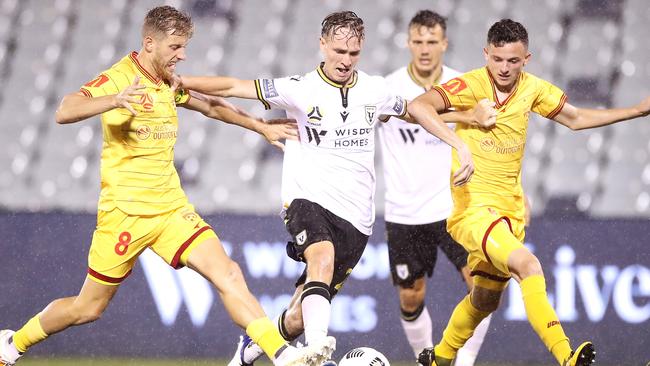 Jake Hollman of Macarthur FC takes on the Adelaide United defence.