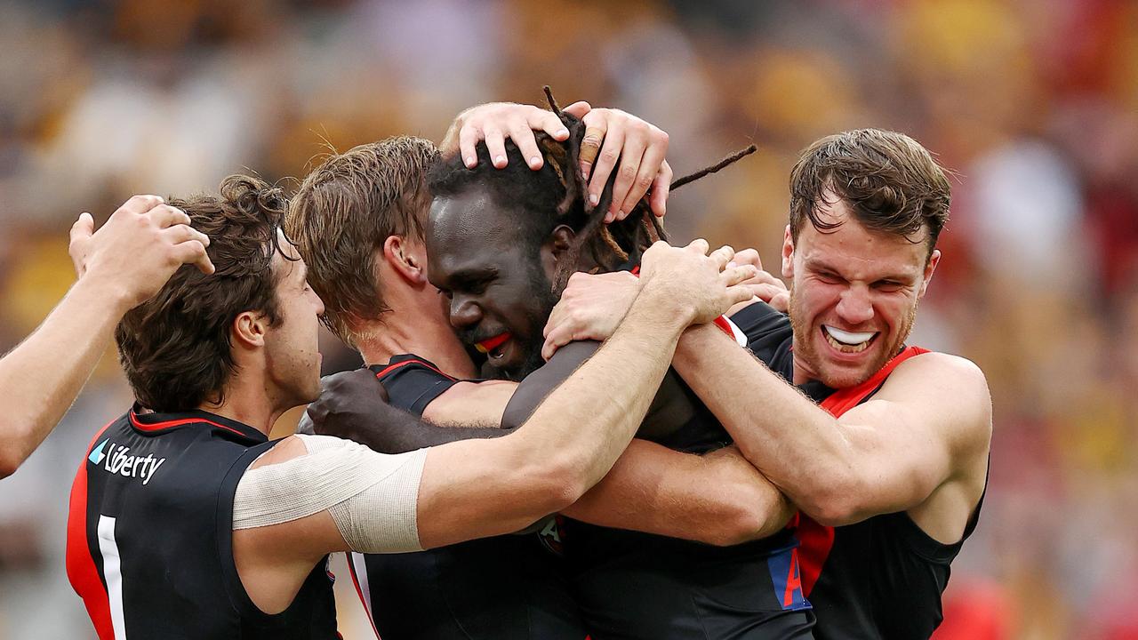 MELBOURNE . 19/03/2023. AFL Round 1. Hawthorn vs Essendon at the MCG. Anthony McDonald-Tipungwuti of the Bombers celebrates a 4th quarter goal with teammates . Pic: Michael Klein