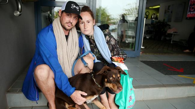 Heavy rain continues to batter the NSW mid north coast causing major flooding in Port Macquarie and surrounding towns. Kris Preussner with his fiance Katrina Leighton and their dog Mac at the flood evacuation centre in Laurieton. Picture: Nathan Edwards