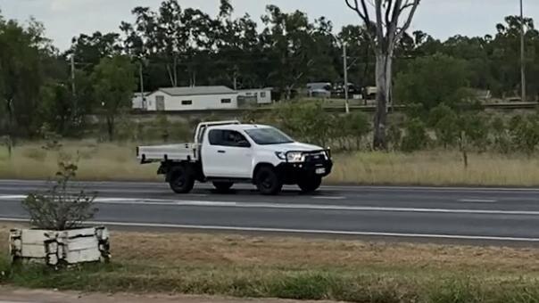 A stolen white Hilux passing the Dingo Roadhouse.