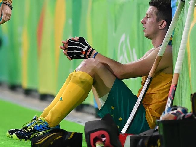 Australia's Simon Orchard sits on the field at the end of the men's quarterfinal field hockey Netherlands vs Australia match of the Rio 2016 Olympics Games at the Olympic Hockey Centre in Rio de Janeiro on August 14, 2016. / AFP PHOTO / MANAN VATSYAYANA