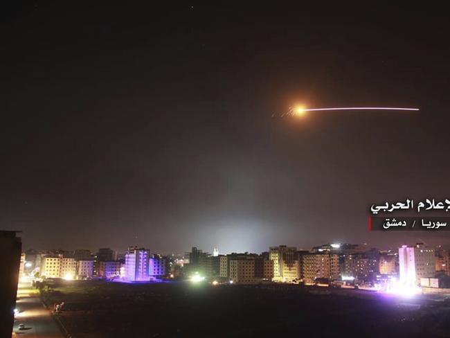 This photo provided early Thursday, May 10, 2018, by the government-controlled Syrian Central Military Media, shows missiles rise into the sky as Israeli missiles hit air defense position and other military bases, in Damascus, Syria. The Israeli military on Thursday said it attacked 