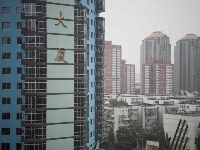 The residential luxury homes of Guangcai (top right) are seen in Beijing's Chaoyang district on September 29, 2016. China's richest man, real estate magnate Wang Jianlin, has warned the country's property market is the "biggest bubble in history" -- the latest alarm bell to be sounded on the world's second largest economy. / AFP PHOTO / FRED DUFOUR