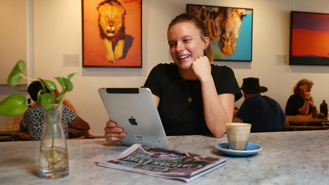 News junkie Laquicia Woolbank catches up on the latest news with iPad and the Cairns Post app. Picture: Brendan Radke