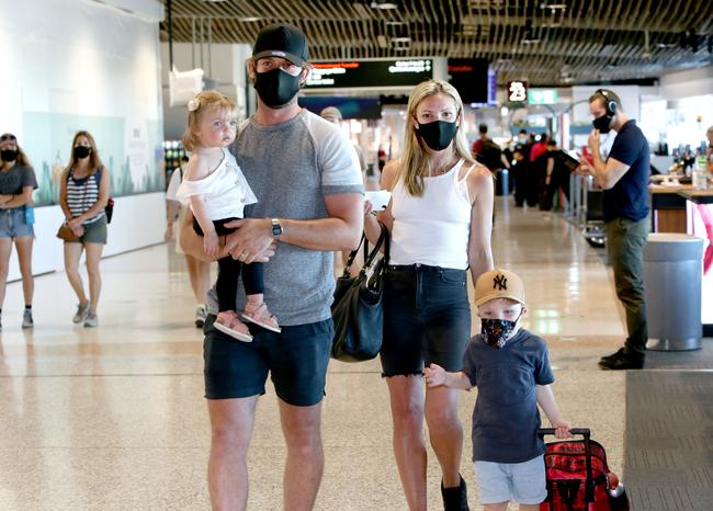 Anthony and Natalie Molloy with kids Bella, 1, and Finn, 4, heading home to Melbourne from Brisbane Airport. Picture: Steve Pohlner.