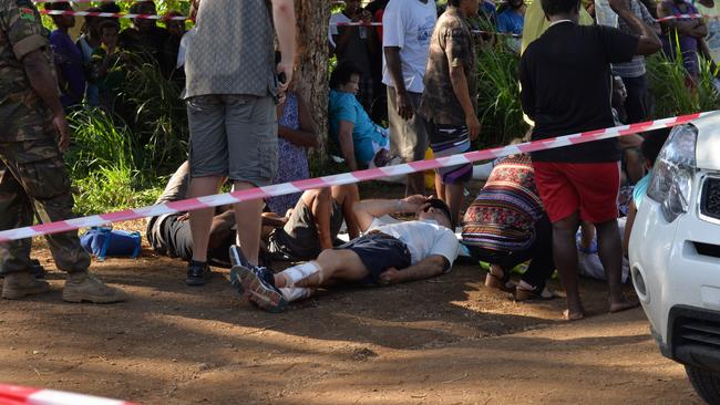 Supplied image obtained Tuesday, June 21, 2016 of the scene of a tour bus crash in Vanuatu's capital of Port Vila. At least 12 Australians were seriously injured when their tour bus collided with a bus carrying locals on Monday night. Three locals have died from their injuries. (AAP Image/Glenda Shing) NO ARCHIVING, EDITORIAL USE ONLY