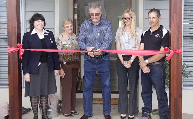 Gympie Mayor Ron Dyne (centre) cuts the ribbon to officially open Stirling Homes Queensland’s new display home at Curra as councillor Rae Gate (left) Mayoress Dulcie Dyne and Stirling Homes’ Karen and Peter Bazzan look on. Picture: David Crossley