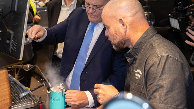 Scott Morrison is shown how to make a coffee as he visits Kiwanda Cafe and Zarraffa Coffee Roasters in the electorate of Forde in Eagleby near Brisbane. Picture: Jason Edwards