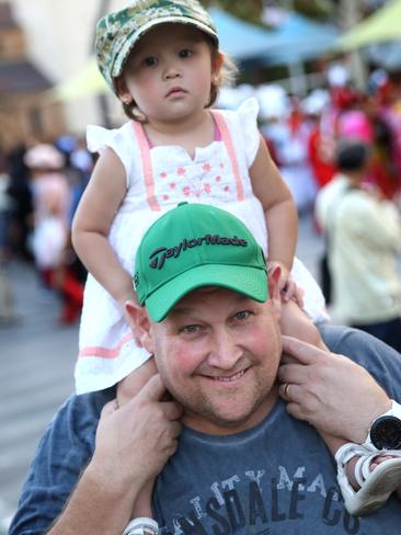 Catherine, 1, and her father Christian Hansen from Baulkham Hills check out the Welcome Parade on Friday.